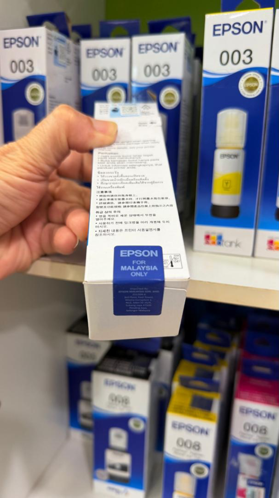 Bottom view of Epson box showing blue tamper-evident security tape for Malaysia only
