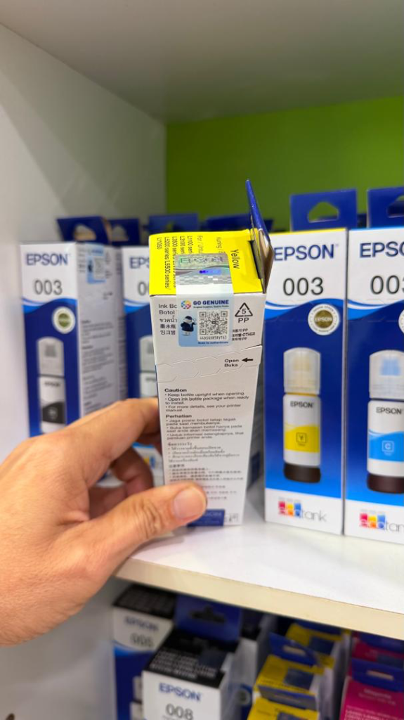 Top view of Epson 003 box showing iridescent hologram sticker and GO GENUINE QR code